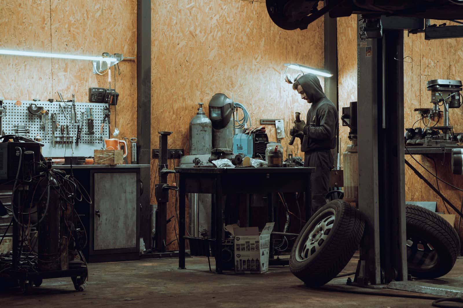 A tradesman working on a machine in a workshop