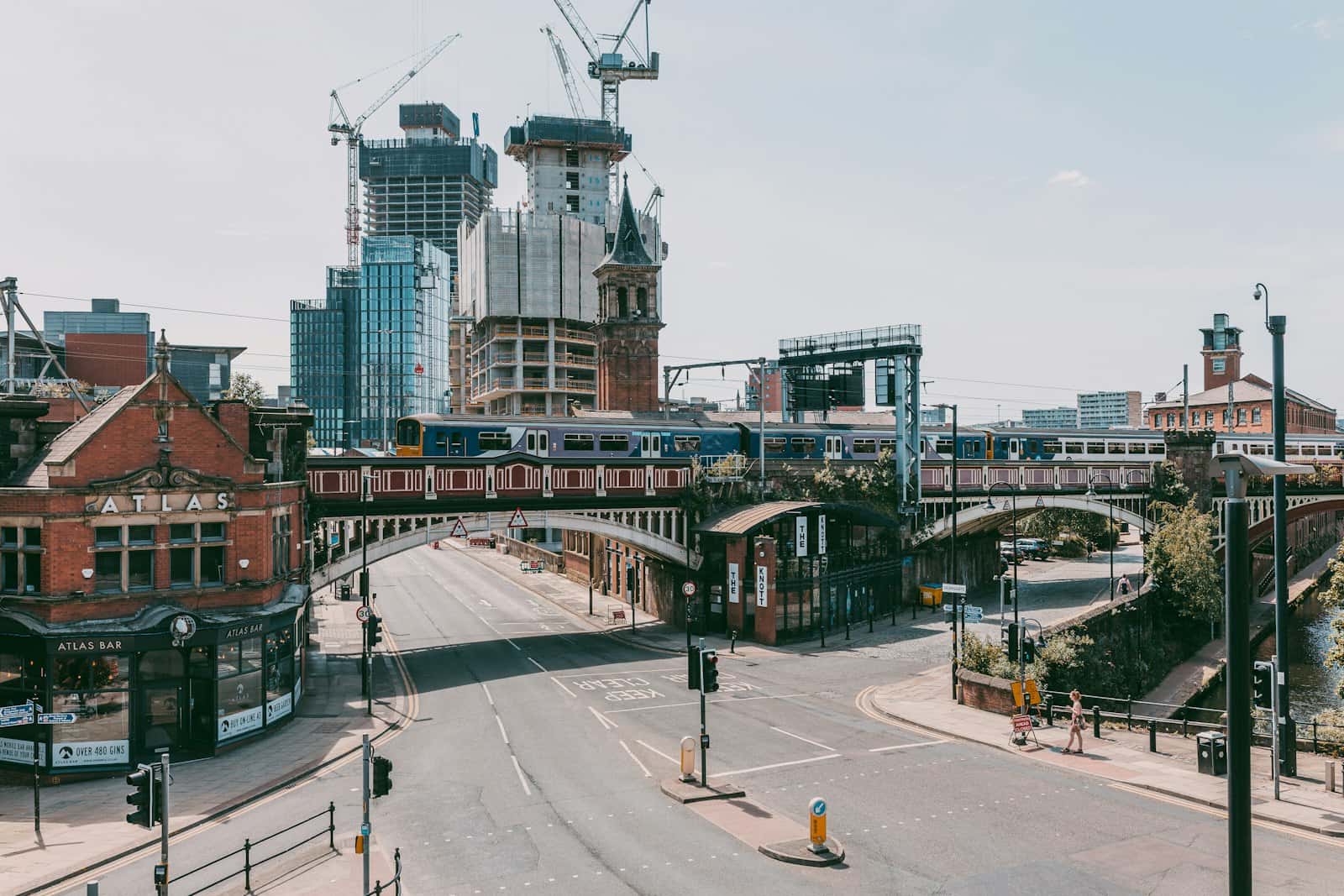 People walking past buildings in central Manchester